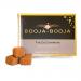 A compact rectangular box of Booja-Booja Fine De Champagne truffles sits on a neutral background. Matte brown packaging bears gold lettering and an elegant logo. A clear window shows eight round, cocoa-dusted truffles nestled in a neat paper tray. Soft shadows accentuate textures, scene remains calm