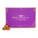 A rectangular box displays five glossy artisanal chocolate truffles nestled in paper cups, each with distinct swirls, nuts, or dustings. The matte sleeve features elegant gold lettering and botanical illustrations set against a deep, rich brown backdrop. Subtle shadows accentuate round edges softly.