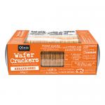 A clear plastic pack reveals rectangular thin wafer crackers stacked neatly, their pale golden layers showing crisp ridges and toasted sesame seeds scattered across the surface. A warm-toned label with a rustic bakery logo sits at the top of the package.