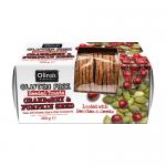 A clear-wrapped pack of twelve gluten-free seeded toasts shows thin rectangular slices studded with dried cranberries and green pumpkin seeds. Crusts are golden-brown, surface is textured with seeds and grains, and a white label reads Olina’s Bakehouse Bakery. A small sticker lists visible items....