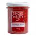 Six clear glass jars sit in a neat group, each topped with a metallic lid. Deep, glossy crimson jam fills the jars, flecked with chili seeds. Clean white labels display bold red and black lettering reading Single Variety Co Fireflame Chilli Jam, against a plain studio background. Subtle jar shadows.