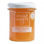 A clear glass jar with a metal screw-top displays Single Variety Co Seville Orange Marmalade. The amber-orange preserve shows a glossy, translucent sheen with suspended strips of bitter Seville peel and a chunky, pulpy texture. A clean label wraps the jar with simple typography. Soft highlights show