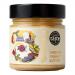 A clear jar of Butternut of London Smooth Peanut Butter sits on a neutral surface. The jar shows a creamy, glossy tan spread with a smooth top. A clean label wraps the jar with the brand name and simple graphics; a screw lid finishes the package. Soft studio lighting creates a gentle highlight. Tone.