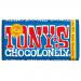 A carton containing 15 Tony’s Chocolonely Dark Chocolate 70% bars, each in bright yellow wrappers accented with bold red stripes and the handwritten Tony’s logo. Individual bar labels show '70% dark' and weight; bars sit stacked and slightly askew inside the box.