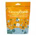 Six glossy pouches display the Yummycomb logo atop warm amber and brown packaging. Each 100g bag shows honeycomb graphics, caramel drizzle and chocolate squares with a sprinkle of sea salt. Pouches sit stacked and slightly angled, revealing resealable tops and nutrition panels. Neutral grey backdrop