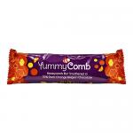 A Yummycomb dark orange chocolate bar sits on a neutral surface. Glossy deep-brown chocolate contrasts with a bright orange filling visible at a clean break. The wrapper displays the brand name; the exposed interior shows fine snap lines and tiny orange zest flecks. Under soft light the sheen gleams.