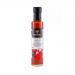 Six 250ml clear bottles of bright red Sriracha stand in a neat cluster. Each bottle shows a white label reading The Coconut Kitchen with a small coconut icon and white cap. The vivid sauce contrasts with the crisp, tropical-style label.