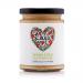 Six 250g tubs of Lucy’s Dressings Vegan Chilli Mayonnaise sit in a neat cluster. Each clear plastic pot shows creamy, pale-orange sauce; white labels with red accents and brand name encircle the tubs. The image uses a plain background and soft, even lighting. Labels show small chili graphic and text.