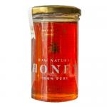 Six clear glass jars of Maters & Co Raw Orange Blossom Honey sit in two neat rows on a pale surface. Amber honey gleams through the glass; each jar has a white screw-top lid and a bright label showing the Maters & Co name and orange-blossom artwork.