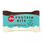 Glossy box shows Vive Chocolate Minis Hazelnut branding in bold text across warm brown and cream panels. Small hazelnut-studded chocolate bites form a scattered cluster, while subtle nutritional icons and a clear serving-size marker appear on the front. A small window shows one mini at lower corner.