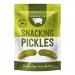 A tidy array of 24 small 40 g packs of Serious Pig Snacking Pickles, each clear-front pouch revealing bright green pickles and a bold pig logo on colorful labeling. Packs sit evenly on a neutral background with soft, even lighting.