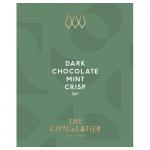 Glossy dark-green wrapper frames a slender dark chocolate bar embossed with crisp mint flecks. The label displays elegant gold lettering and subtle botanical mint illustrations. A single square is broken, revealing dense, glossy interior studded with tiny pale mint crystals. Fine ridges catch light