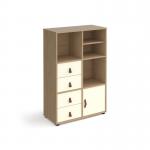 This photograph features a sleek oak cube storage unit, standing at 1295mm high and equipped with glides. It comes with a matching shelf, cupboard, and 2 sets of drawers, all with white inserts for a clean and modern touch. The overall design is versatile and functional, perfect for any living space.