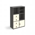 The photo shows a sleek grey storage unit with white inserts, standing at 1295mm tall on glides. It includes a matching shelf, cupboard, and two sets of drawers, creating a versatile and functional cube storage solution.