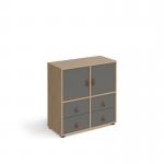 This picture captures a modern and versatile storage unit, standing at 875mm with glides for easy movement. It features 2 cupboards and 2 sets of drawers, all with sleek oak and grey inserts for a stylish touch. A perfect addition to any living space or office.