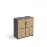 This photo features a sleek grey and oak cube storage unit, standing at 875mm high and equipped with glides for easy movement. It includes 2 cupboards and 2 sets of drawers, providing ample storage space. The design is versatile and modern, perfect for any room in your home.