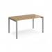 A modern and versatile single desk from Dams Bench Desking Adapt. The desk features a sleek silver frame and a natural oak top, measuring 1400mm by 800mm. Perfect for any home or office space.