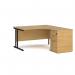 The image shows a sturdy and modern right hand ergonomic desk with a black cantilever frame and an accompanying desk high pedestal. The desk is made of oak and has a length of 1400mm. It is designed to provide comfort and efficiency for the user.