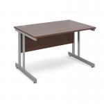 This image shows a sleek and modern Dams International Desking Momento straight desk measuring 1200mm x 800mm. It features a silver cantilever frame and a rich walnut tabletop. The desk appears to be sturdy and functional, perfect for a productive work environment.