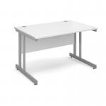 The photo shows a sleek and modern silver cantilever framed desk with a white top. The desk measures 1200mm x 800mm and is labeled as the Dams International Desking Momento straight desk. The clean lines and neutral color scheme make it a versatile addition to any workspace.