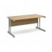 The picture shows a sleek, modern desk with a silver cantilever frame and an oak top. The desk is 1600mm long and 800mm wide, providing plenty of workspace. Its design is suitable for use in an international office setting.