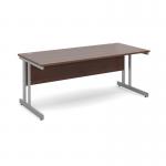 This image shows a sleek, modern desk with a silver cantilever frame and a walnut top. The desk measures 1800mm x 800mm and is from Dams Internationals Desking Momento collection. Its straight design provides a spacious work area, while the combination of silver and walnut gives it a sophisticated appearance.