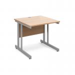 The photograph depicts a sleek and modern desk, measuring 800mm x 800mm. The silver cantilever frame provides sturdy support, while the top is made of beech wood, adding a touch of elegance. Designed for international desking, this desk is both functional and stylish.