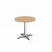 This photo features a stylish circular dining table with a 4 leg chrome base measuring 800mm in diameter. Made of oak, this Dams Round Tables Roma is simplistic yet elegant, perfect for any modern dining room.