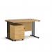 The photo shows a sleek black cantilever frame supporting a beautiful oak desk, measuring 1200mm x 800mm. A 3 drawer pedestal provides storage. This Dams Pedestal Desk exudes professionalism and sophistication.
