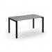 This photo shows a modern Dams Bench Desking Connex Scalloped desk with a black frame and grey oak top. The desk measures 1400 x 800 x 725mm and is designed for single use. The scalloped edges add a touch of unique style to the desks clean and sleek design.