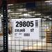 The photograph features a durable warehouse signage with a wire hanging document pocket attached. There are 50 ticket holders with flaps, designed to hold A4 documents. The holders are clear, allowing for easy visibility and organization of important papers.