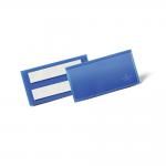The photo shows a stack of 50 Durable Adhesive Ticket Holder Document Pockets in blue, each measuring 100 x 38mm. The durable warehouse signage stands out and is easy to read. The photo captures the high-quality and functional design of the product.