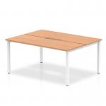 This photo features a sleek, modern office workspace with a Dynamic Bench Desking Evolve Plus desk. The desk has a 1400mm oak top and white frame, perfect for a 2 person office. The space is designed for productivity and collaboration.
