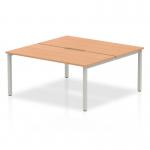This image features an Evolve Plus 1600mm B2B bench desk with an oak top and silver frame, designed for 2 people to use in an office setting. The dynamic design encourages collaboration and efficient use of space.