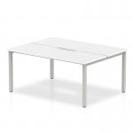 This image shows a sleek and modern white bench desk, measuring 1400mm, with a silver frame and enough space for 2 people to comfortably work side by side. The design of this dynamic bench desk, called Evolve Plus, is perfect for a professional and modern office environment.