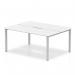 This image shows a sleek and modern white bench desk, measuring 1400mm, with a silver frame and enough space for 2 people to comfortably work side by side. The design of this dynamic bench desk, called Evolve Plus, is perfect for a professional and modern office environment.