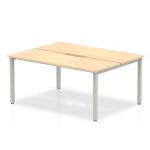 The Dynamic Bench Desking Evolve Plus 1200mm B2B 2 Person Office Bench Desk features a sleek maple top and a sturdy silver frame. Its compact size is perfect for two people to work side by side, making it ideal for collaborative projects in the office.
