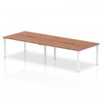 This picture shows a dynamic bench desking setup with the Evolve Plus 1200mm B2B office bench desk. It features a sleek walnut top and a modern white frame, creating a professional and stylish workspace for up to four people. The design is both functional and visually appealing, making it a great addition to any office space.