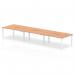 This picture showcases a sleek and modern workstation - the Dynamic Bench Desking Evolve Plus 1400mm B2B 6 Person Office Bench Desk. With a beautiful oak top and white frame, this desk is spacious and perfect for a team of 6 people. It exudes a professional and professional aesthetic, making it an ideal addition to any office space.