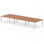 The photograph captures a modern 6-person office bench desk, with a sleek walnut top and silver frame. The dynamic design of the bench desking allows for a comfortable and efficient work environment. Its spacious 1600mm size makes it perfect for group projects and collaboration.