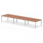This image showcases a sleek and modern office space with a dynamic bench desking system. The 1400mm desk features a rich walnut top and a silver frame, perfect for accommodating 6 people in a productive and collaborative work environment.