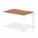 This picture features a sleek and modern office bench desk, measuring 1200mm, with a stylish walnut top and a clean white frame. This dynamic bench desking set exudes a professional and efficient vibe, perfect for any modern workspace.
