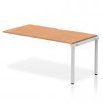 This image features a sleek and modern office bench desk, measuring 1600mm in length. The desk has an oak top with a silver frame, creating a dynamic and stylish look. It is designed for single rows and is part of the Evolve Plus collection.