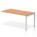 This image features a sleek and modern office bench desk, measuring 1600mm in length. The desk has an oak top with a silver frame, creating a dynamic and stylish look. It is designed for single rows and is part of the Evolve Plus collection.