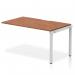 This photo features a sleek and modern Dynamic Bench Desking Evolve Plus desk, measuring 1400mm in length and constructed with a walnut top and silver frame. The single row design provides ample workspace, perfect for any office environment.