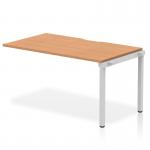 This image features a sleek and modern Dynamic Bench Desking Evolve Plus 1400mm single row office bench desk extension kit in oak top and silver frame. The desk is in a clean and open layout, perfect for collaborative work environments.