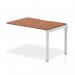 This photograph features a sleek and modern Dynamic Bench Desking Evolve Plus 1200mm Single Row Office Bench Desk Ext Kit in walnut with a silver frame. The streamlined design and premium materials give off a professional and stylish vibe, making it perfect for any office space.