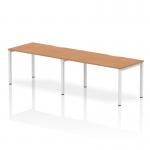 This image showcases a sleek and modern bench-style desk, with a 1400mm oak top and white frame. The desk is designed for two people, and is perfect for a dynamic and collaborative office space. The clean lines and ergonomic design make it a stylish and functional addition to any workspace.