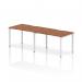 A sleek and modern office setup, this photo features a Dynamic Bench Desking Evolve Plus 1200mm Single Row 2 Person Office Bench Desk in walnut with a white frame. The clean lines and ample workspace make this desk perfect for a collaborative environment.