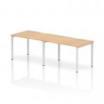This image features a spacious desk with a maple top and white frame, designed for two people in a dynamic office setting. The bench desking system promotes collaboration and efficiency, with a sleek and modern aesthetic.